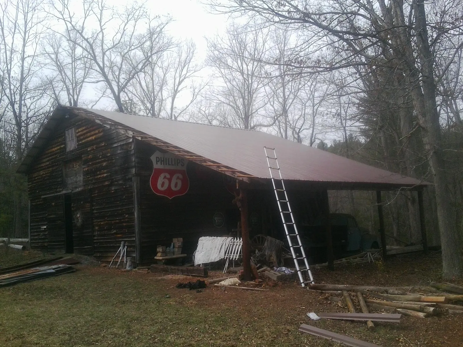 New metal roof on an open sided timber barn with a vintage sign in Henrietta